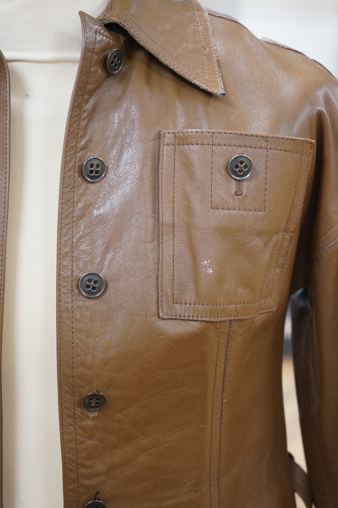 A Baccarat tan leather jacket and a black close-fitting Korean leather jacket size 10